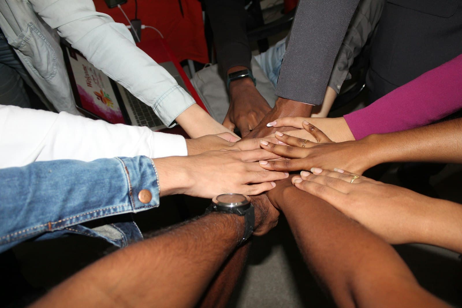 A group of people stacking their hands together